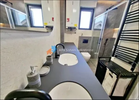 Modern bathroom with double sink, walk-in shower, and built-in fixtures. - image 6
