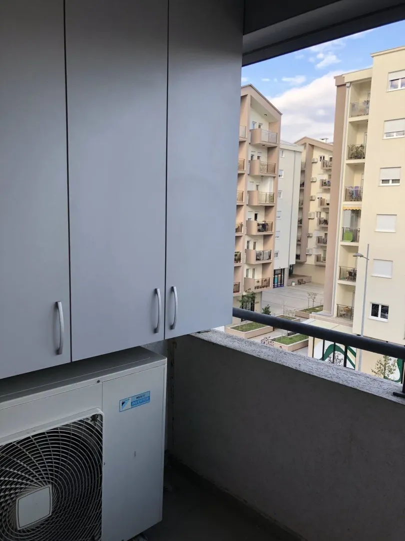Balcony with a cabinet and air conditioner.