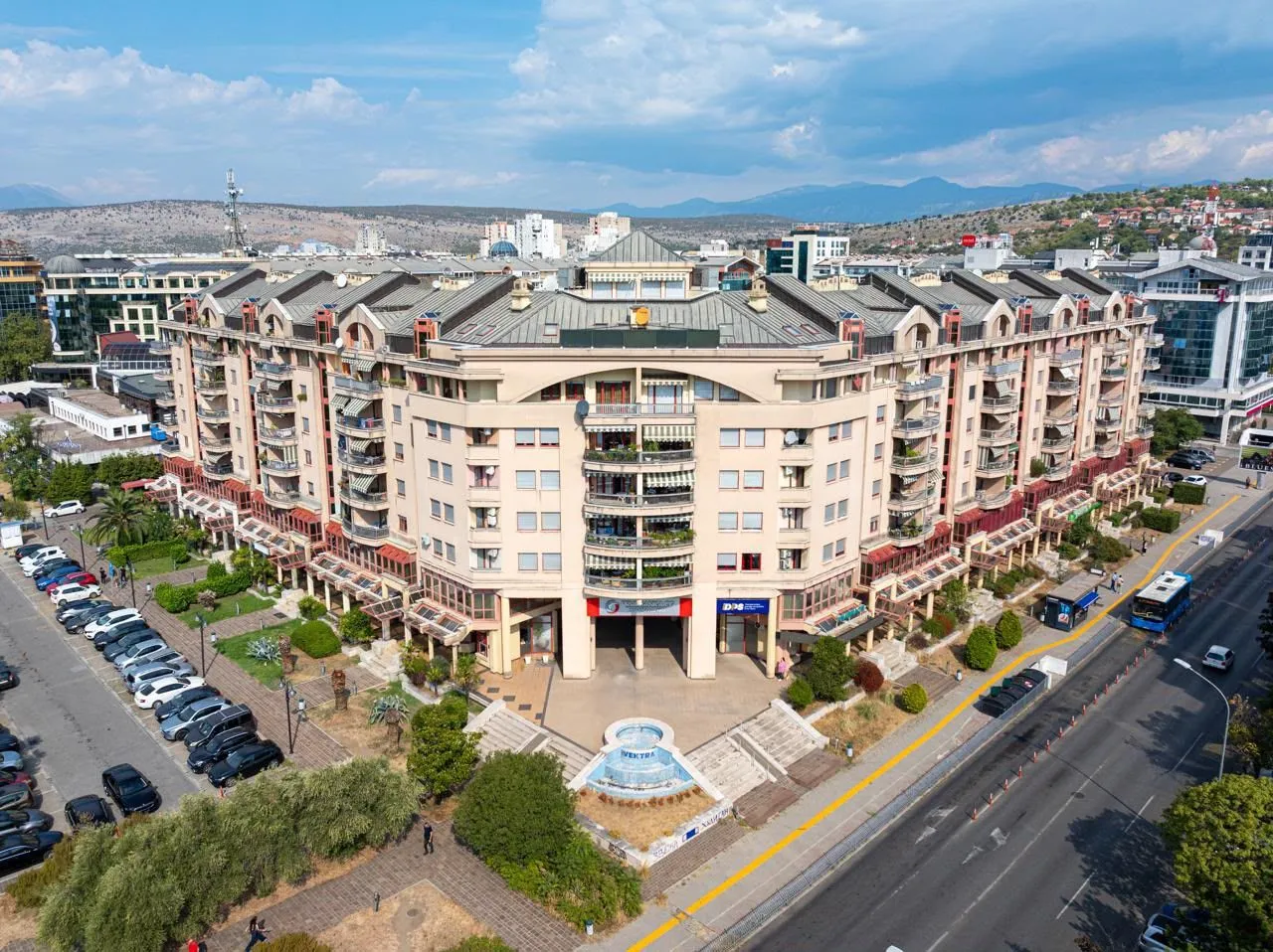 Aerial view of the exterior of the residential building and surroundings.
