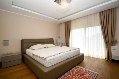 Spacious bedroom with a double bed, wooden flooring, and terrace access. - image 19