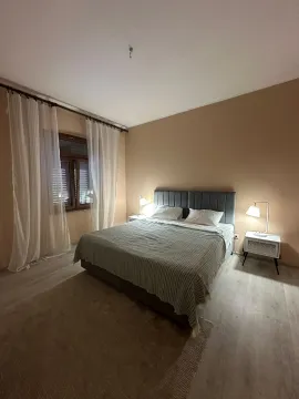 Udobna spavaća soba sa bračnim krevetom, noćnim stočićima i prozorom sa bijelim zavjesama. - image 5