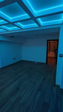 Empty room with a dropped ceiling and blue LED lighting. - image 8