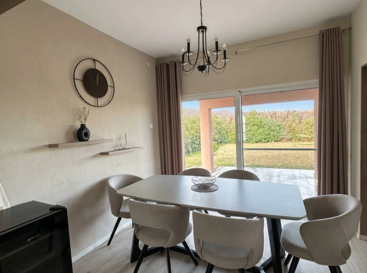 Dining area with a table, chairs, and access to the yard.
