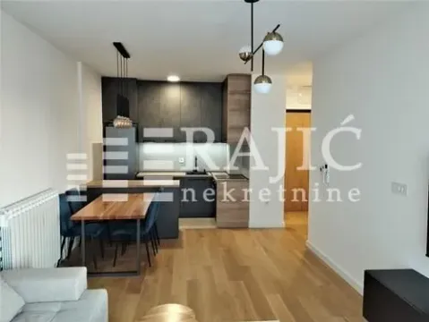 Modern kitchen with a dining area and living room. - image 3