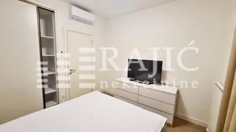 Furnished bedroom with a double bed, wardrobe, and TV. - image 4
