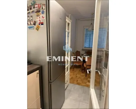 View from the kitchen towards the dining area with a refrigerator and kitchen units. - image 4