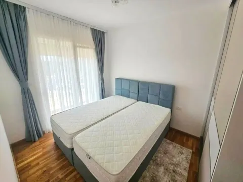Bedroom with a double bed and a window with curtains. - image 4