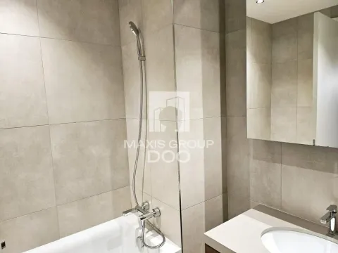 Modernly equipped bathroom with a bathtub and a washbasin. - image 12