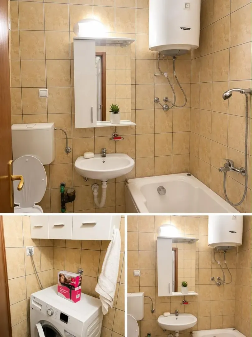 Clear bathroom with a bathtub, washbasin, toilet, and washing machine.