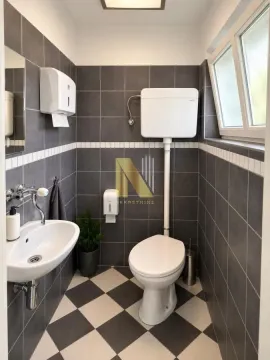 Small bathroom with dark tiles and a checkerboard floor pattern. - image 19
