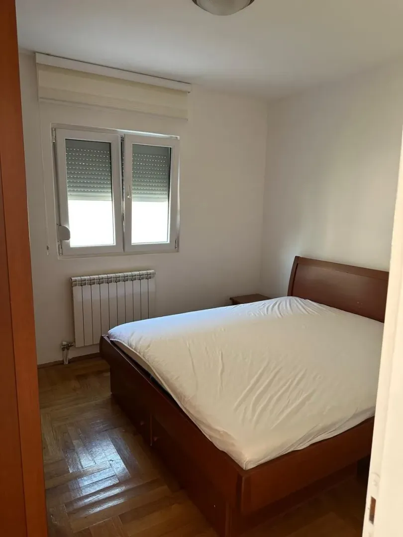 Bedroom with a double bed and a window.