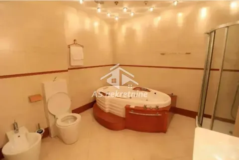 Bathroom equipped with a toilet, bidet, corner hydro-massage bathtub, and a shower cabin. - image 18