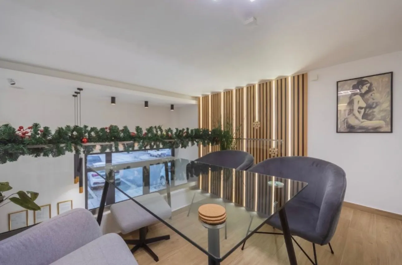 Modern living room interior with a dining table and decorative wooden wall panels.