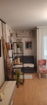 Small living room with a shelving unit and sofa. - image 7
