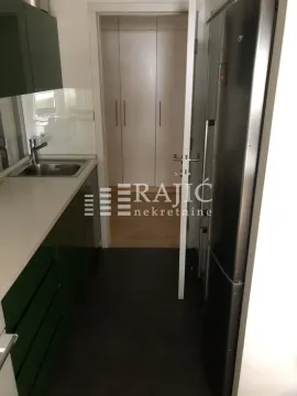Small kitchen with a sink, green cabinets, and a refrigerator. - image 5