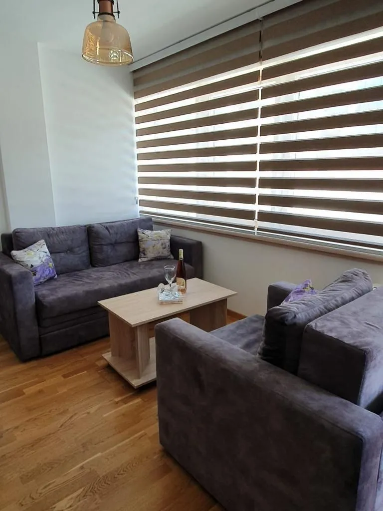 Living room with a sofa set and a large window.