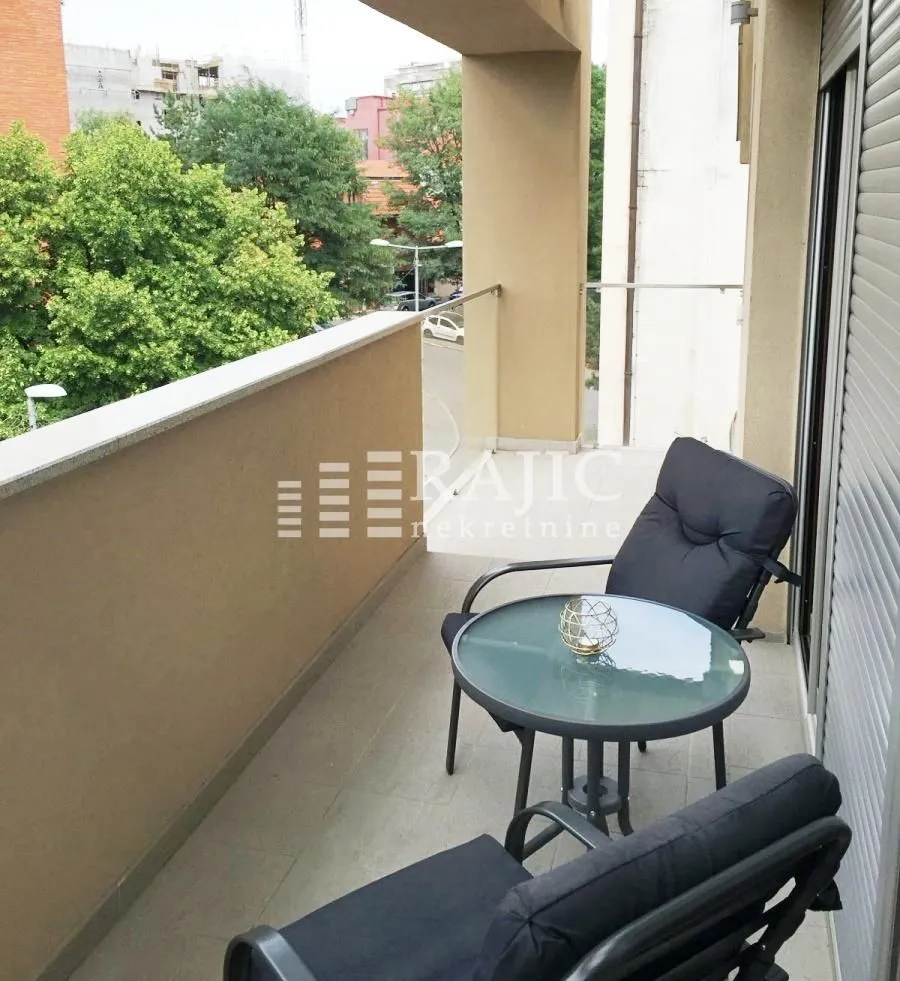 Small furnished balcony with outdoor seating.
