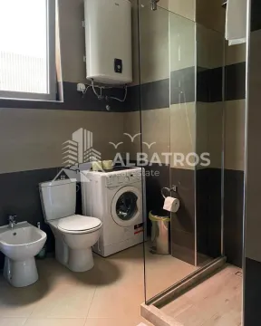 Bathroom equipped with sanitary fixtures, a shower cabin, and a washing machine. - image 11