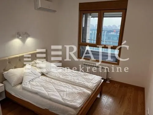 Furnished bedroom with a double bed and a window.