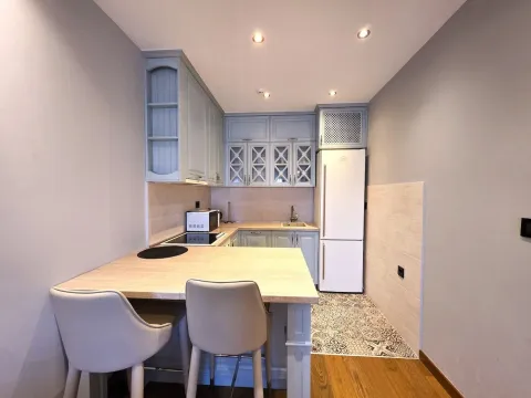 Small kitchen with a dining table and chairs. - image 4