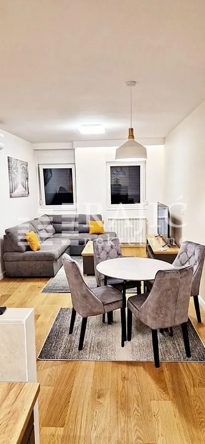 Living room with a sofa and dining table.