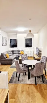 Living room with a sofa and dining table. - image 3