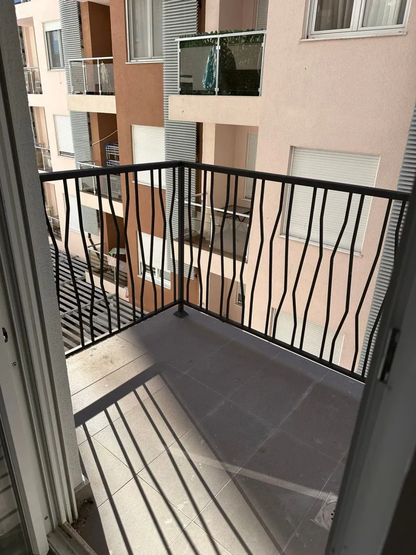 View from the tiled balcony towards the neighboring building.