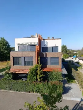 View of the exterior of a modern residential building with a landscaped yard. - image 32