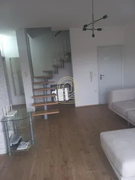 Living room with a sofa, staircase, and entrance door. - image 2