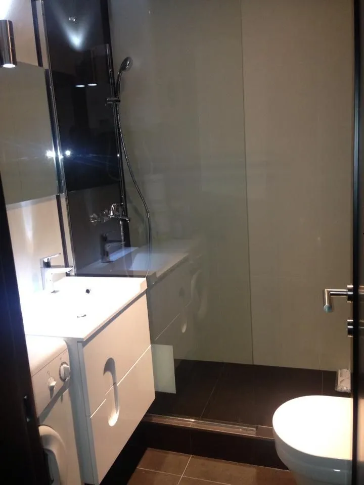 Moderno opremljeno kupatilo sa tuš kabinom, umivaonikom i wc šoljom.