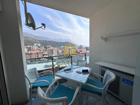 Furnished terrace with table, chairs and a view of the city and mountains. - image 15