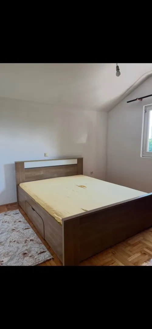 Bedroom with a double bed and parquet flooring.