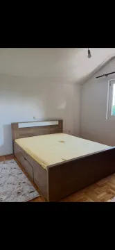 Bedroom with a double bed and parquet flooring. - image 7