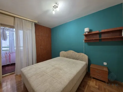 Bedroom with a double bed, wardrobe, and balcony access. - image 12