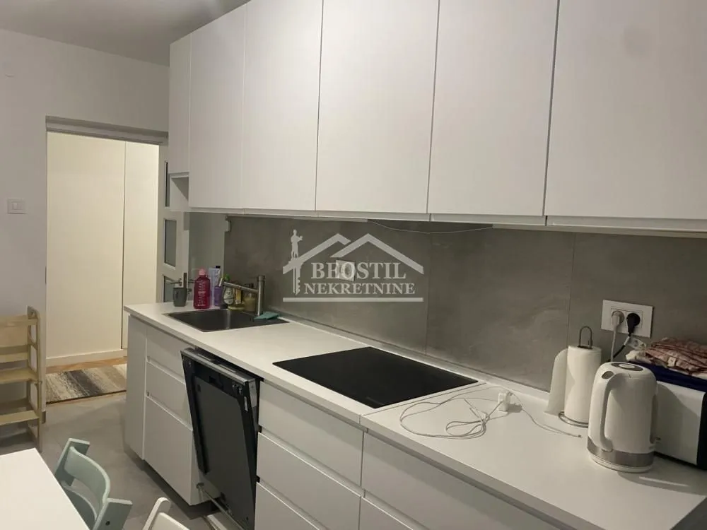 Modern white kitchen with a sink and built-in units.