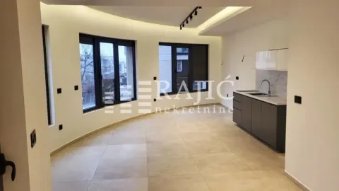 Modern kitchen space with built-in units in a spacious living area. - image 3
