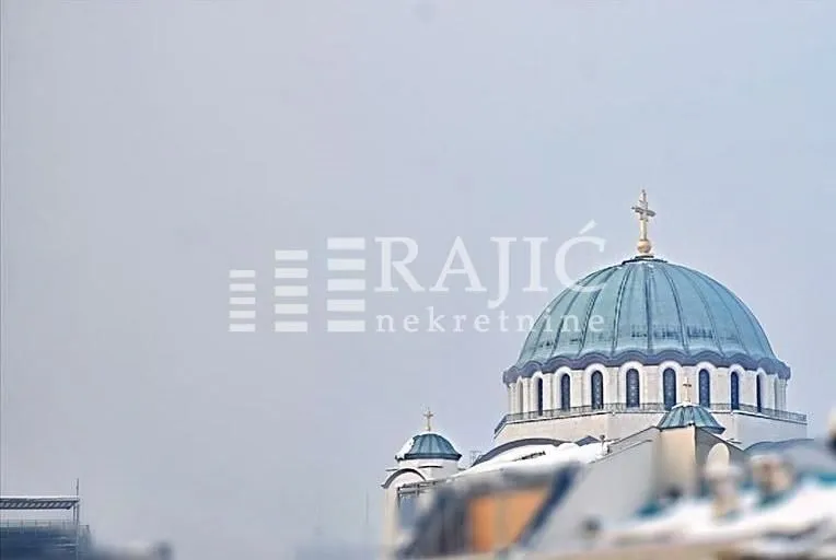 View of a religious building and rooftops.