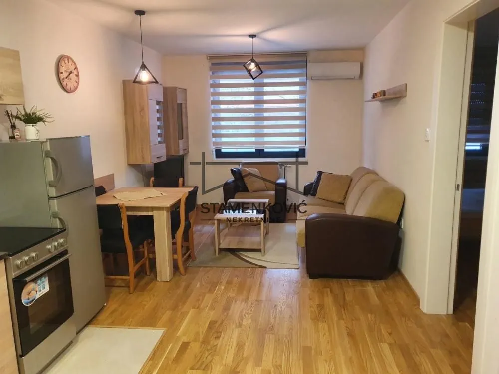 Living room with dining area and kitchen in an open space layout.