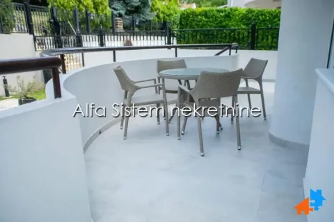 Spacious semicircular terrace furnished with outdoor seating. - image 18