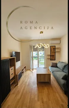 Living room with a sofa, wooden furniture, and access to the terrace. - image 4