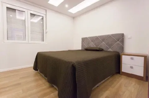 Bright bedroom with a double bed and nightstands. - image 9