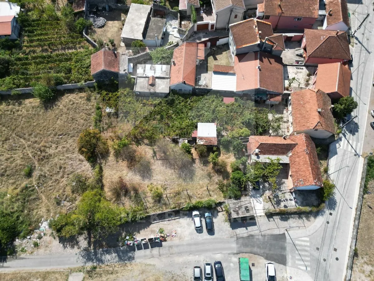Pogled iz vazduha na imanje sa okolnim kućama i dvorištem.