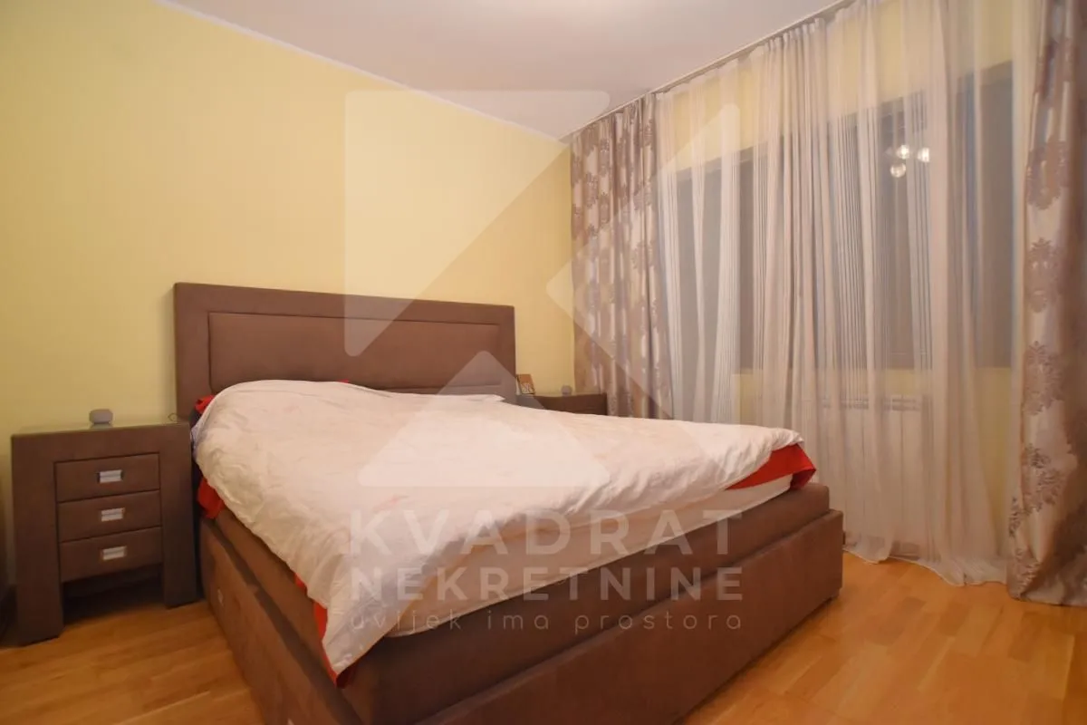 Furnished bedroom with a double bed and a nightstand.