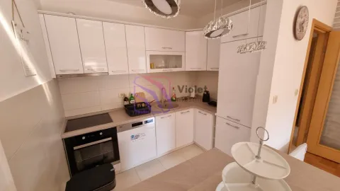 Small white kitchen with built-in oven, hob, and dishwasher. - image 4