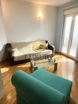 Living room with a sofa set and a glass coffee table. - image 4