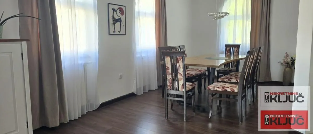 Spacious dining area with a wooden table and chairs.