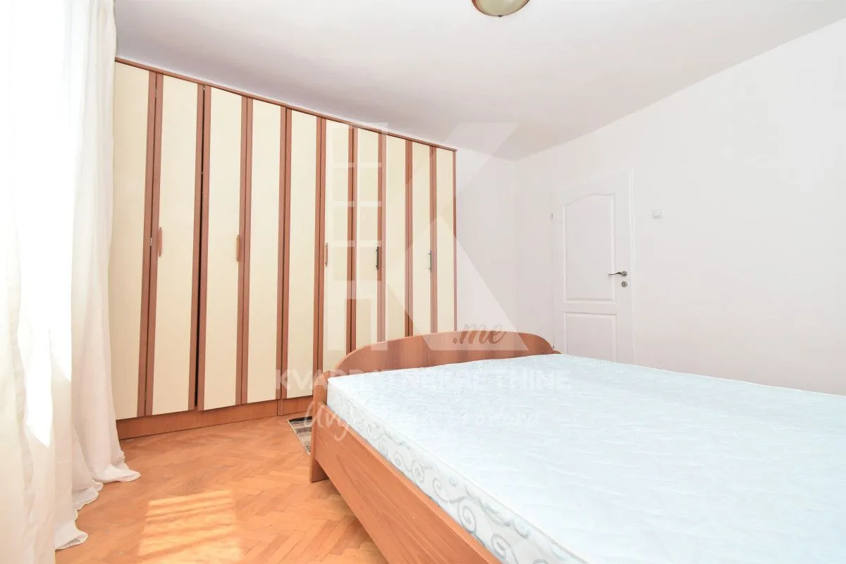 Bedroom with a large double bed and built-in wardrobe.