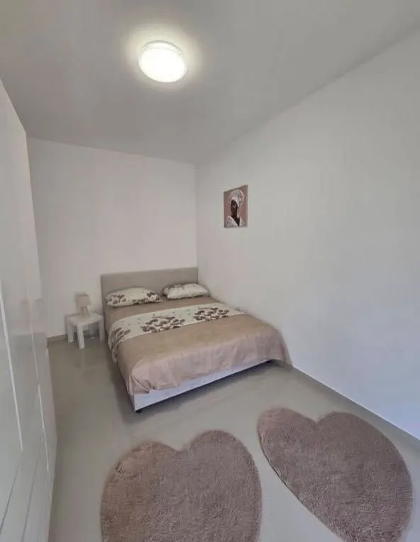 Svjetla i uredna spavaća soba sa bračnim krevetom.