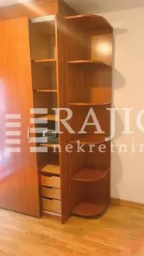 Wooden wardrobe with open shelves in a room. - image 9