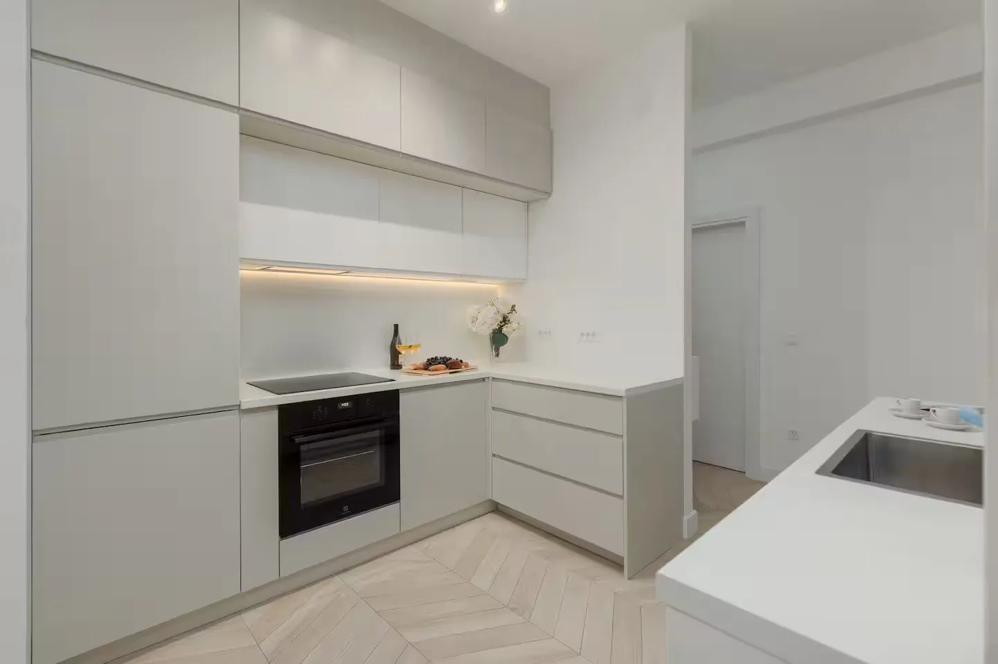 Modern kitchen with built-in cabinetry and white countertops.